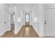 Bright hallway with wood floors and paneled walls leading to other rooms at 121 Nate Ct, Wake Forest, NC 27587