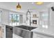 Kitchen island with a stainless steel sink, with fireplace and screened porch in the background at 121 Nate Ct, Wake Forest, NC 27587