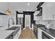 Modern kitchen featuring stainless steel appliances, farmhouse sink, gas range, and pantry at 121 Nate Ct, Wake Forest, NC 27587