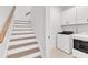 A well-organized laundry room with washer and dryer, conveniently located next to the staircase at 121 Nate Ct, Wake Forest, NC 27587