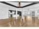 Open-concept living area connects kitchen, dining, and screened porch with hardwood flooring at 121 Nate Ct, Wake Forest, NC 27587