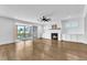 Bright living room with hardwood floors, a fireplace, and screened porch access at 121 Nate Ct, Wake Forest, NC 27587