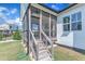 Screened porch featuring wooden steps and a ceiling fan, offering a cozy transition to the backyard at 121 Nate Ct, Wake Forest, NC 27587