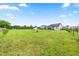 Expansive backyard featuring a playground and ample space for outdoor activities and relaxation under a clear blue sky at 137 Clydes Point Way, Wendell, NC 27591