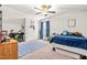 Stylish bedroom featuring a blue rug, desk and double closet at 137 Clydes Point Way, Wendell, NC 27591