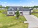 Home's exterior features include manicured lawn and a two-car garage, creating a welcoming curb appeal at 137 Clydes Point Way, Wendell, NC 27591