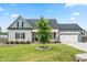 Charming two-story home with a manicured lawn, two car garage, and a welcoming front porch at 137 Clydes Point Way, Wendell, NC 27591
