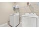 Bright laundry room features a modern washer and dryer, with storage shelf above at 137 Clydes Point Way, Wendell, NC 27591