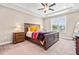 Spacious bedroom features tray ceilings, fan, and a large window that provides ample natural light at 137 Clydes Point Way, Wendell, NC 27591