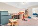 Spacious playroom provides ample space for children to play with a playhouse, furniture, and toys at 137 Clydes Point Way, Wendell, NC 27591