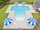 Aerial shot of a community pool surrounded by lounge chairs and umbrellas, offering a refreshing oasis for residents at 137 Clydes Point Way, Wendell, NC 27591