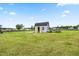 Backyard shed offering additional storage or a potential workshop space, complemented by a well-maintained lawn at 137 Clydes Point Way, Wendell, NC 27591