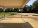 A partially-covered wood deck overlooks a spacious backyard surrounded by lush greenery at 145 Tee Dr, Selma, NC 27576