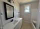 Well-lit bathroom with a large mirror, stylish vanity, and modern fixtures at 145 Tee Dr, Selma, NC 27576