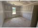 Bedroom under construction, featuring a large window and a door at 145 Tee Dr, Selma, NC 27576