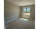 A cozy bedroom with a large window allowing natural light, perfect for relaxation and rest at 145 Tee Dr, Selma, NC 27576