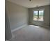 A well-lit bedroom with a window overlooking the landscape, providing a serene and comfortable space at 145 Tee Dr, Selma, NC 27576