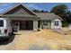 View of a home under construction, featuring a two-car garage and green siding at 145 Tee Dr, Selma, NC 27576