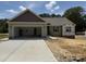 Charming single-story home with attached garage and well-lit entranceway on a sunny day at 145 Tee Dr, Selma, NC 27576