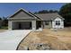 Charming single-story home featuring an attached two-car garage and lovely architectural details at 145 Tee Dr, Selma, NC 27576
