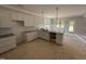 Bright kitchen featuring white cabinets, granite countertops, and a stylish faucet at 145 Tee Dr, Selma, NC 27576