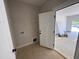 Functional laundry room with storage shelf and easy access to the garage at 145 Tee Dr, Selma, NC 27576