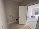A new laundry room with hookups, a nearby utility sink, and an exterior access door at 145 Tee Dr, Selma, NC 27576