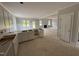 Bright living room connected to kitchen, featuring a cozy fireplace and multiple windows at 145 Tee Dr, Selma, NC 27576