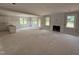 Open-concept living room with a fireplace, large windows, and adjacent kitchen space ready for customization at 145 Tee Dr, Selma, NC 27576