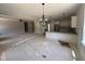 Spacious living area connecting to the kitchen with modern lighting fixtures and ample space at 145 Tee Dr, Selma, NC 27576
