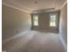 A primary bedroom offering a tray ceiling and large windows offering ample natural light at 145 Tee Dr, Selma, NC 27576