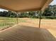 Covered wood patio overlooking the backyard and green space at 145 Tee Dr, Selma, NC 27576