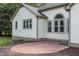 Charming brick patio extending from the house with great flow to the green backyard at 1614 E Hardscrabble Dr, Hillsborough, NC 27278