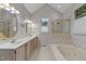 Bathroom featuring a soaking tub, walk-in shower, double sinks, and floral wallpaper at 1614 E Hardscrabble Dr, Hillsborough, NC 27278