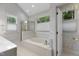 Bathroom with a soaking tub, a shower, and a window for natural light with floral wallpaper at 1614 E Hardscrabble Dr, Hillsborough, NC 27278