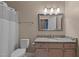 Bathroom featuring granite countertop, a toilet and a shower behind a white shower curtain at 1614 E Hardscrabble Dr, Hillsborough, NC 27278