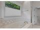 Bright bathroom features a large soaking tub and floral wallpaper, creating a serene atmosphere at 1614 E Hardscrabble Dr, Hillsborough, NC 27278