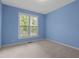 Bedroom featuring light carpet, light blue walls, a window providing natural light at 1614 E Hardscrabble Dr, Hillsborough, NC 27278