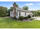 Home's exterior boasts brick chimney, light siding, tidy landscaping, paved patio, and an attached garage at 1614 E Hardscrabble Dr, Hillsborough, NC 27278