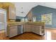 Open kitchen with granite countertops, stainless steel appliances, hardwood floors, and vaulted ceilings at 1614 E Hardscrabble Dr, Hillsborough, NC 27278