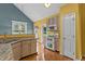 Bright kitchen with stainless steel appliances, granite counters, and wood floors for easy cleaning at 1614 E Hardscrabble Dr, Hillsborough, NC 27278