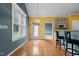 Sun-drenched kitchen with stainless steel appliances, barstool seating, and hardwood flooring at 1614 E Hardscrabble Dr, Hillsborough, NC 27278