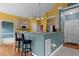 Eat-in kitchen featuring granite countertops, bar seating, stainless steel refrigerator, and hardwood floors at 1614 E Hardscrabble Dr, Hillsborough, NC 27278