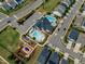 Overhead view of community amenities with pools, play area, and parking at 1716 Aberdour Dr, Apex, NC 27502