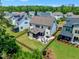 Aerial view of a fenced backyard with outdoor kitchen and fireplace, set in a neighborhood at 1716 Aberdour Dr, Apex, NC 27502