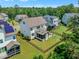 Aerial view of a backyard with firepit and outdoor seating, surrounded by lush greenery at 1716 Aberdour Dr, Apex, NC 27502