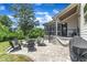 Backyard boasts an outdoor kitchen with grill, covered patio and a paver patio with stone fire pit at 1716 Aberdour Dr, Apex, NC 27502