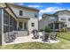 Backyard includes an outdoor kitchen with a grill, patio, and a stone fire pit surrounded by chairs at 1716 Aberdour Dr, Apex, NC 27502