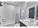 This stylish bathroom features a shower-tub combo with a modern vanity and white subway tile walls at 1716 Aberdour Dr, Apex, NC 27502