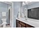 Well-lit bathroom features a modern vanity, a toilet and a shower-tub combo with white subway tiles at 1716 Aberdour Dr, Apex, NC 27502